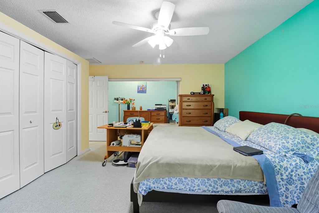 4355 West Justice Court Homosassa, FL 34446 - Photo 9 of 30 a bedroom with a bed and a chandelier