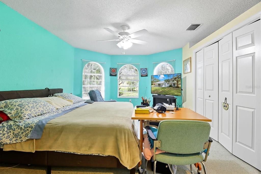 4355 West Justice Court Homosassa, FL 34446 - Photo 10 of 30 a bed room with furniture and a chandelier