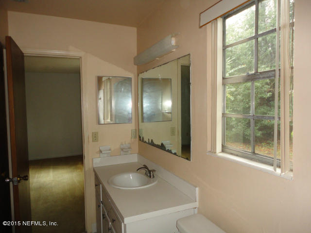 4624 Barnes Road South Jacksonville, FL 32207 - Photo 12 of 13 a bathroom with a sink and a mirror