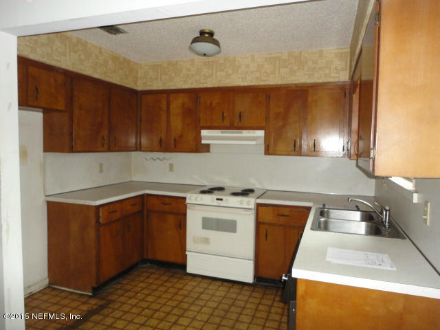 4624 Barnes Road South Jacksonville, FL 32207 - Photo 7 of 13 a kitchen with a stove a sink and a microwave