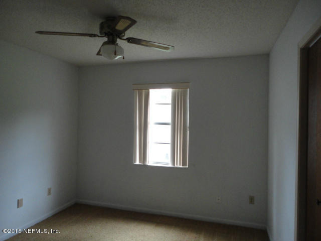 4624 Barnes Road South Jacksonville, FL 32207 - Photo 9 of 13 a view of empty room with ceiling fan and window