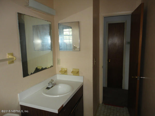 4624 Barnes Road South Jacksonville, FL 32207 - Photo 10 of 13 a bathroom with a sink and a mirror