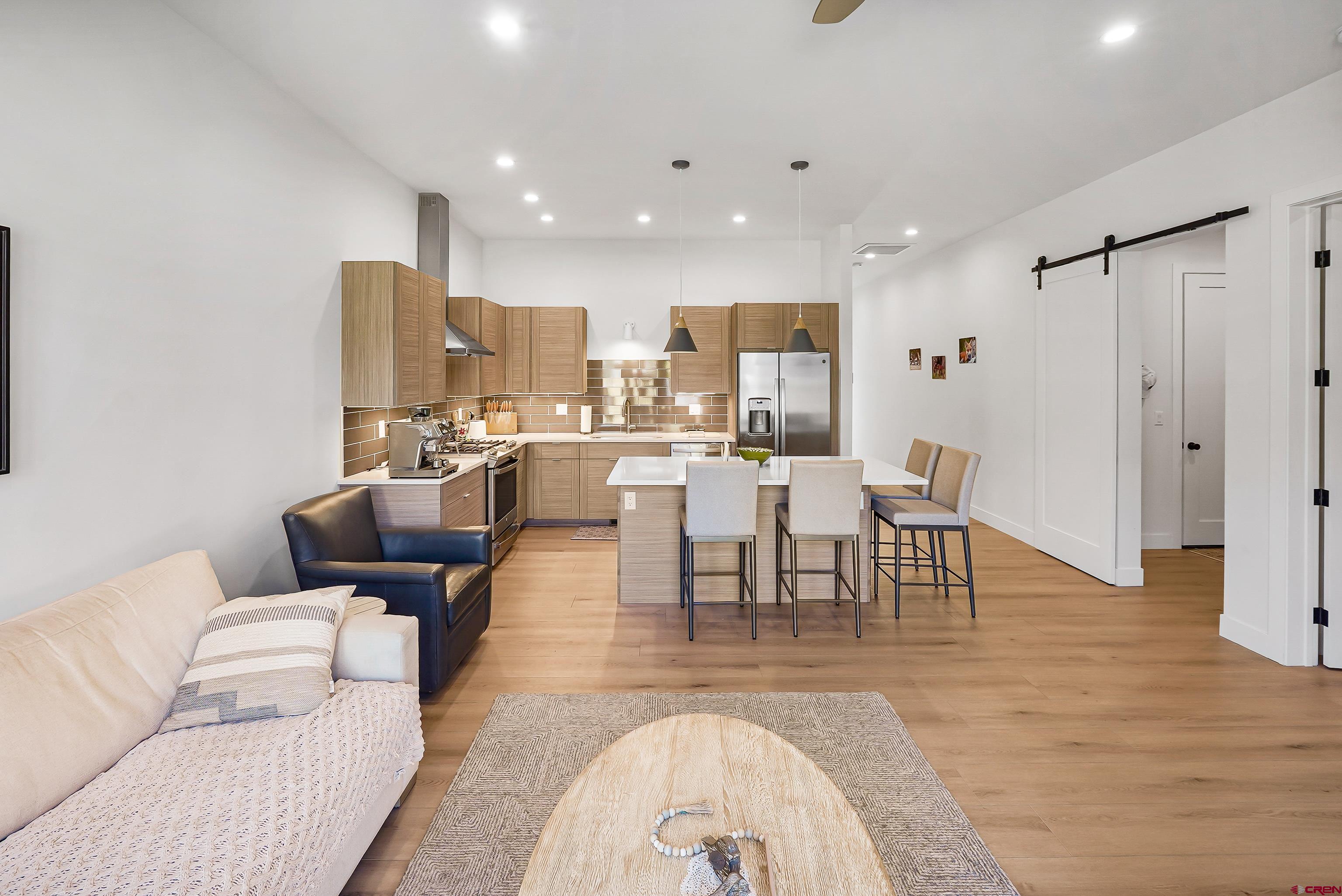 106 Elevation Drive Durango, CO 81303 - Photo 11 of 21 a living room with furniture and a dining table with wooden floor