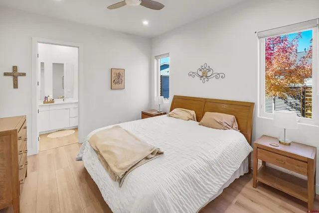 a bedroom with a large bed and a chandelier