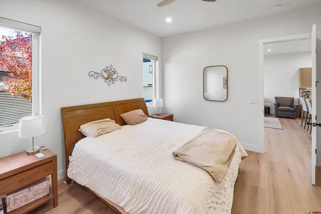 a bedroom with a bed and a chandelier