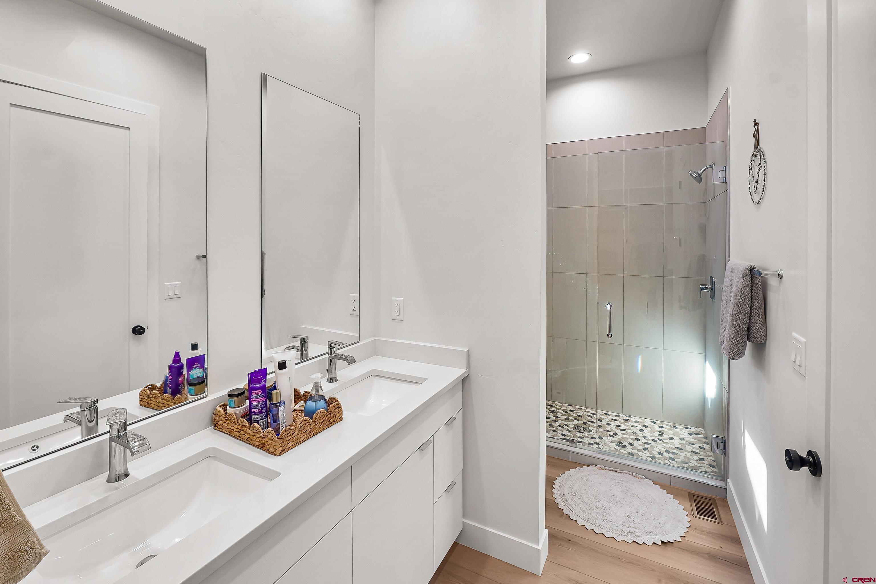 106 Elevation Drive Durango, CO 81303 - Photo 17 of 21 a bathroom with a shower sink vanity and toilet