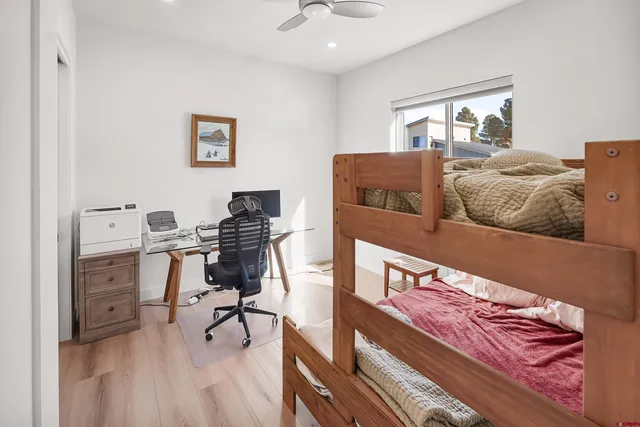 a bedroom with furniture and a wooden floor