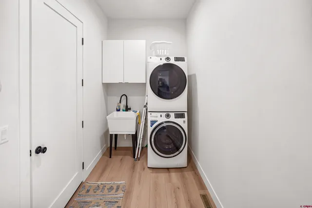 a utility room with sink dryer and washer