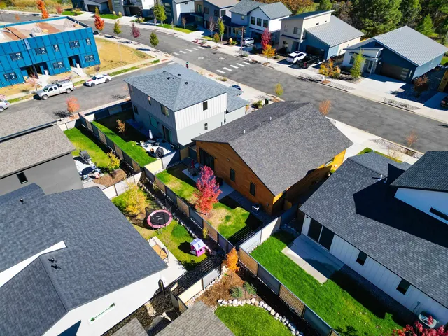 an aerial view of a house with a yard and patio