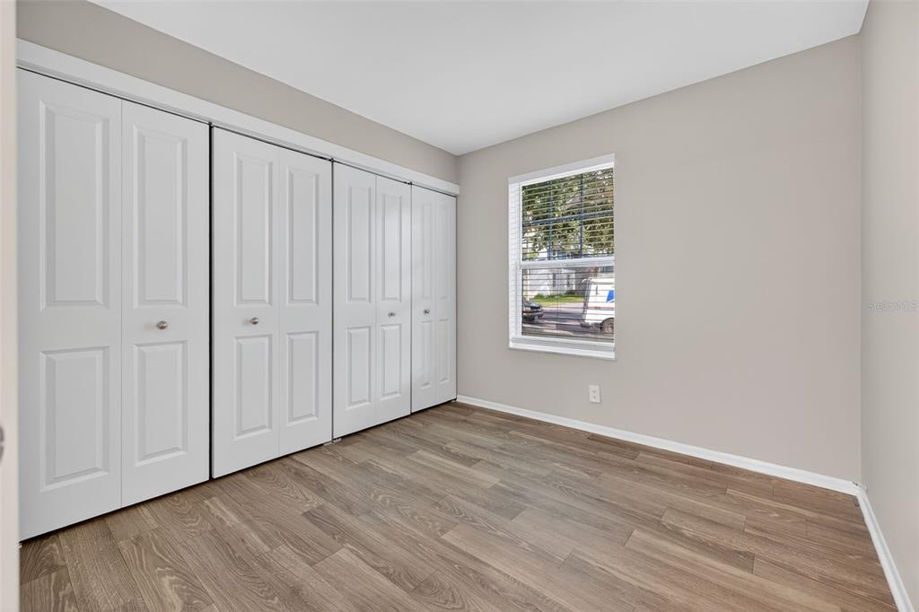 612 Bass Court, Unit 620B Dunedin, FL 34698 - Photo 12 of 32 a view of an empty room with wooden floor