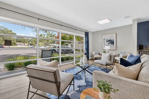 a living room with furniture and a large window