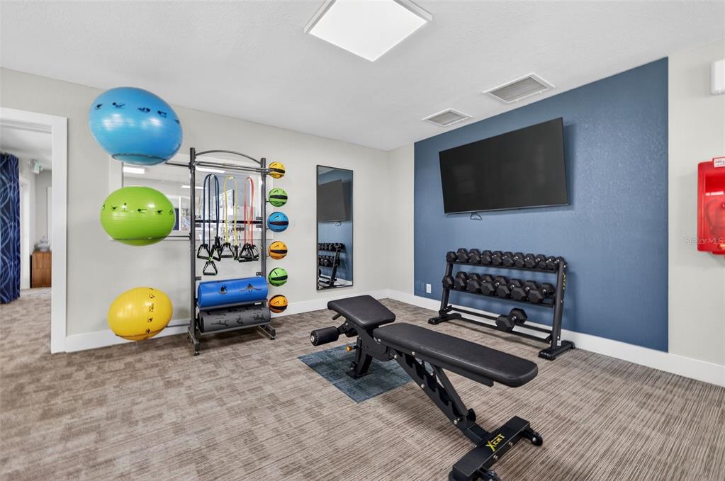 612 Bass Court, Unit 620B Dunedin, FL 34698 - Photo 28 of 32 a living room with furniture and a flat screen tv