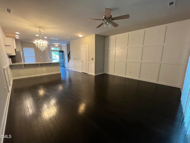 a view of a room with lots of wooden floor and a window