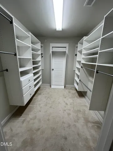 a view of walk in closet with empty racks