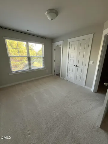 an empty room with a empty space and windows