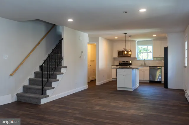 a view of kitchen with sink and stainless steel appliances