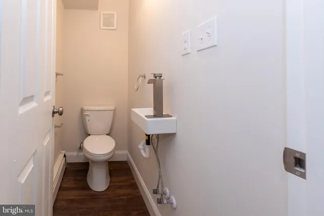 a white toilet sitting next to a sink