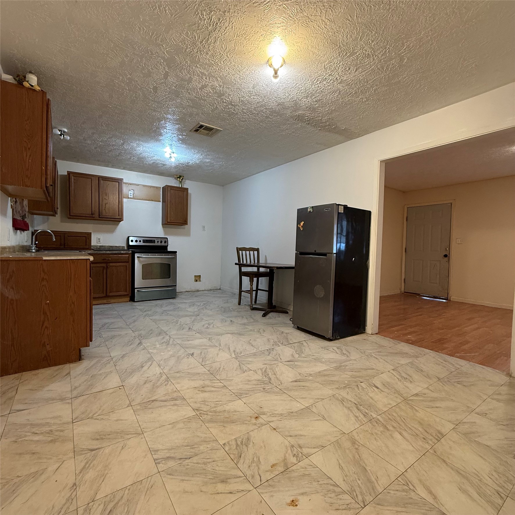 26113 Tyler Park Road Bedias, TX 77831 - Photo 3 of 24 a large kitchen with cabinets and stainless steel appliances