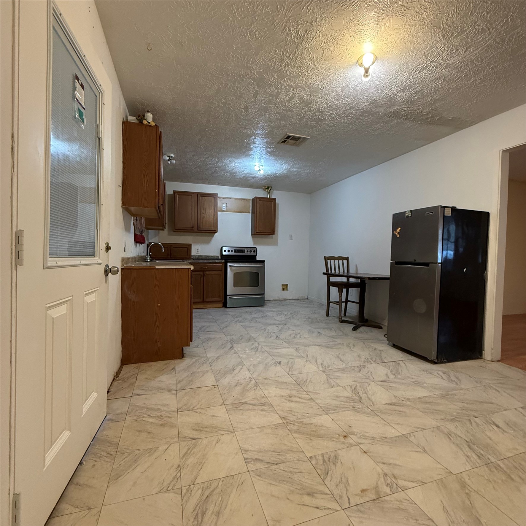 26113 Tyler Park Road Bedias, TX 77831 - Photo 4 of 24 a kitchen with stainless steel appliances granite countertop a refrigerator and a stove