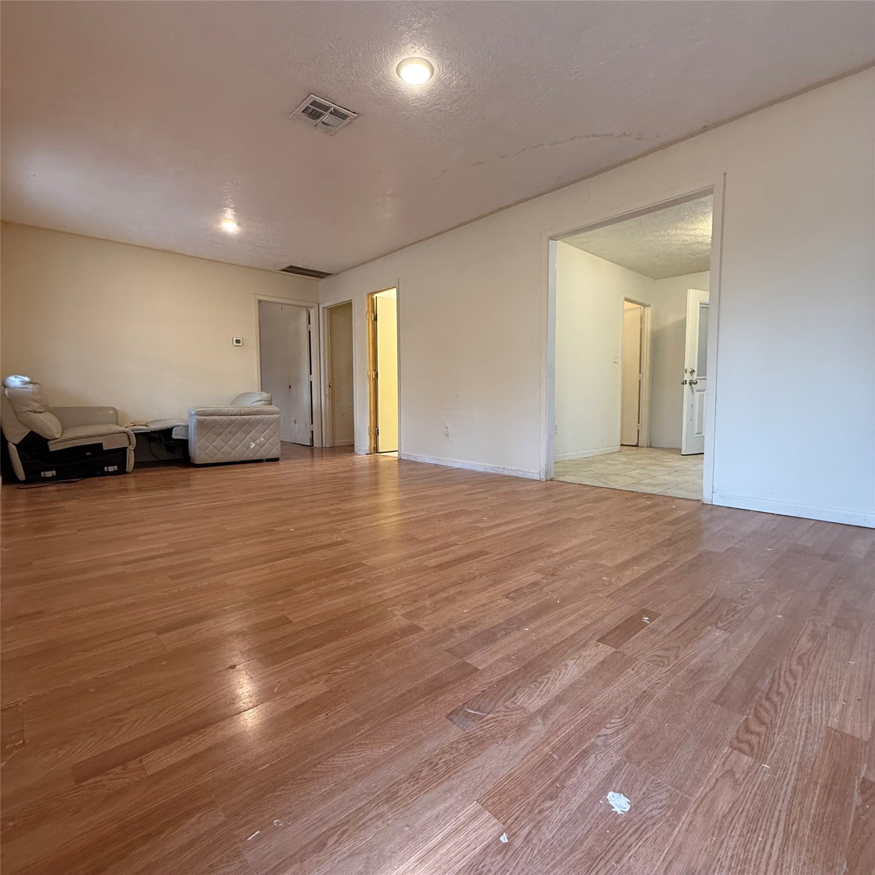 26113 Tyler Park Road Bedias, TX 77831 - Photo 5 of 24 a view of an empty room with wooden floor