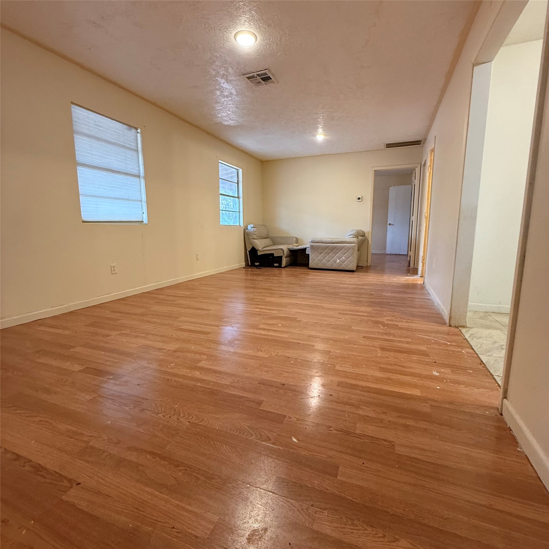 26113 Tyler Park Road Bedias, TX 77831 - Photo 6 of 24 a view of an empty room with window and wooden floor