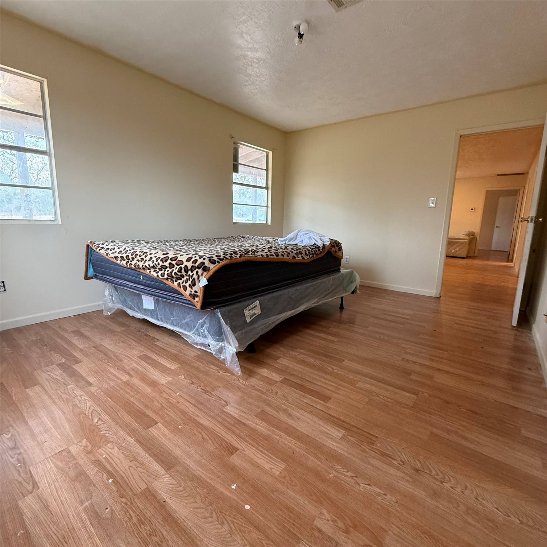 26113 Tyler Park Road Bedias, TX 77831 - Photo 8 of 24 a bedroom with a bed and wooden floor