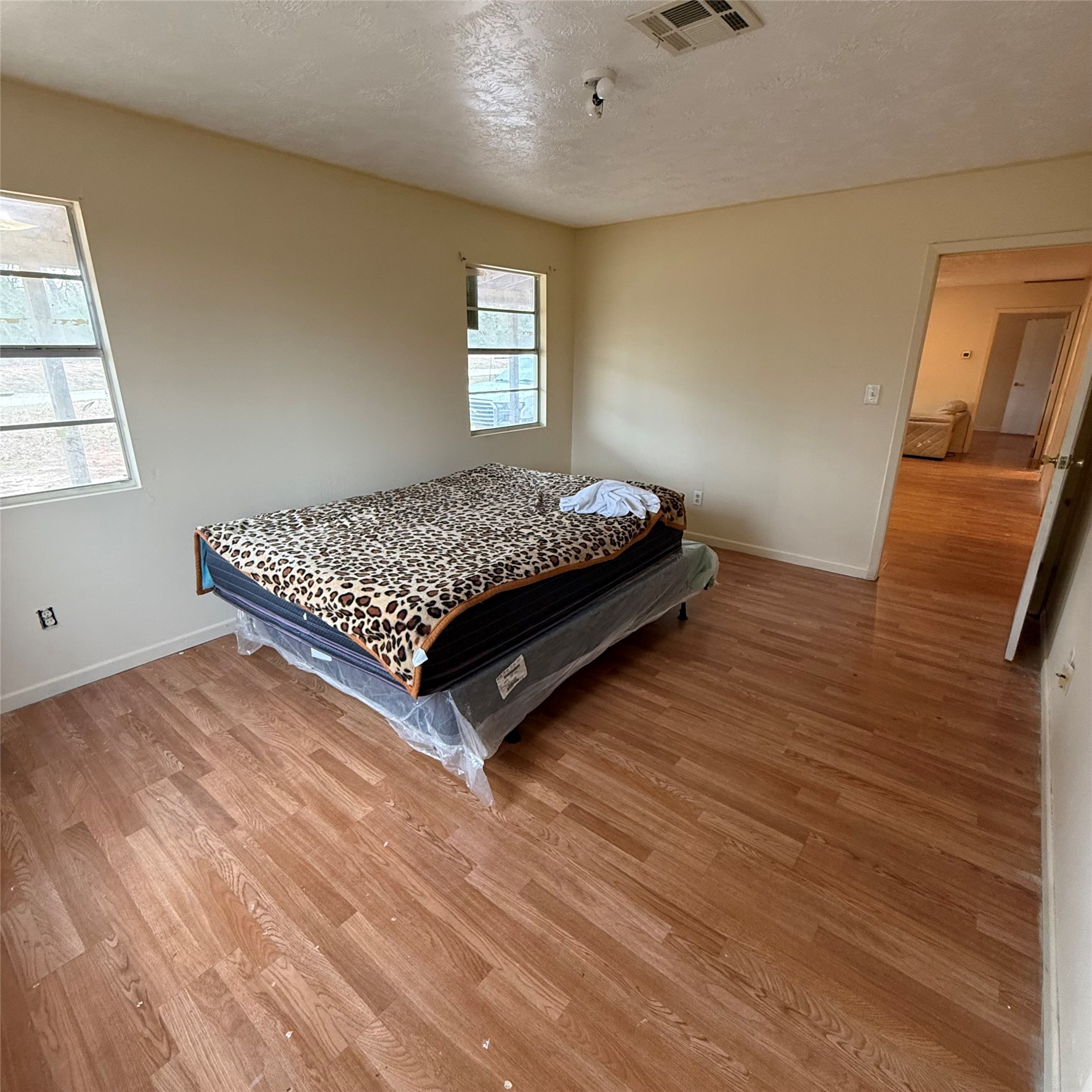 26113 Tyler Park Road Bedias, TX 77831 - Photo 9 of 24 a bed sitting in a bedroom next to a window
