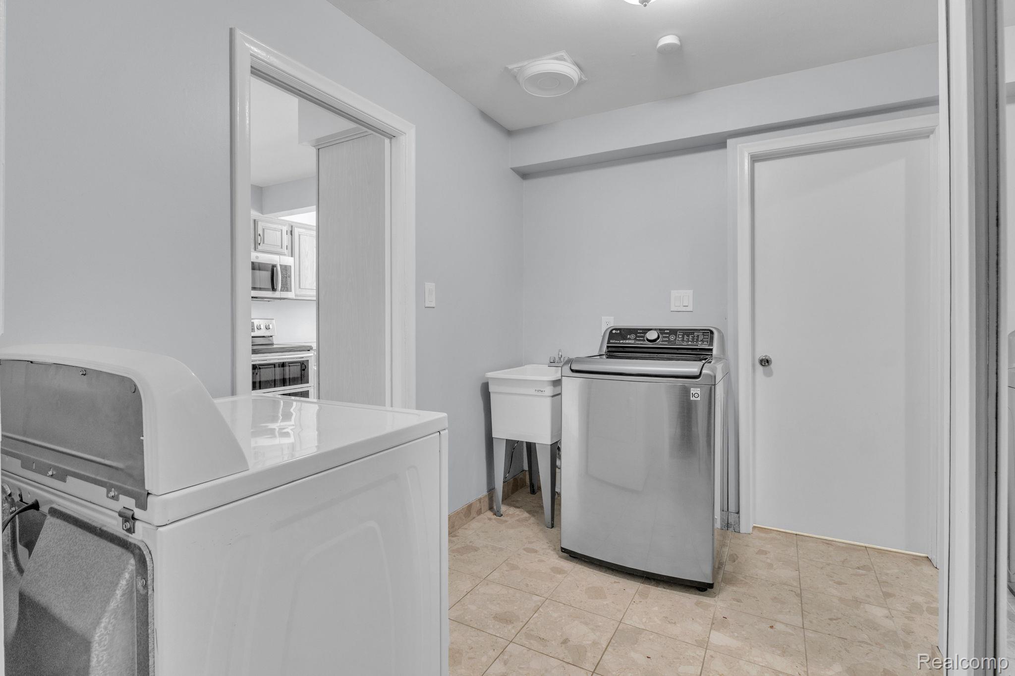 6576 Inkster Road West Bloomfield, MI 48322 - Photo 40 of 62 Laundry area featuring separate washer and dryer and light tile patterned floors