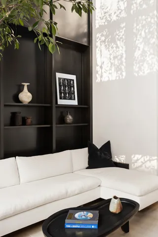 a bedroom with a bed couch and a window