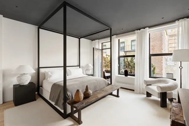 a view of bedroom with a bed and a lamp on table