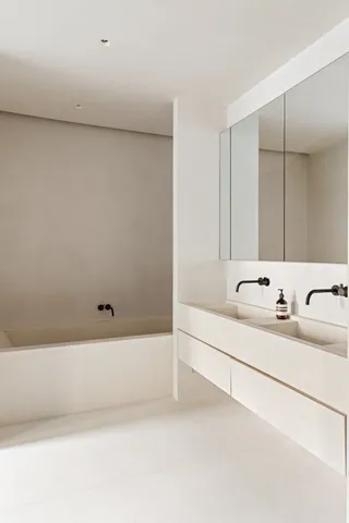 a bathroom with a sink mirror and vanity