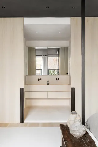 a room with a table chairs and a refrigerator