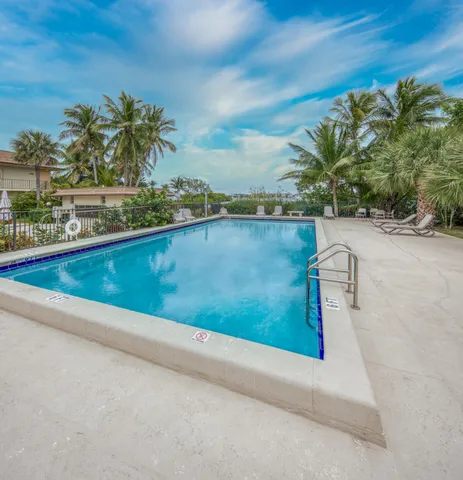 a view of swimming pool with outdoor seating and plants