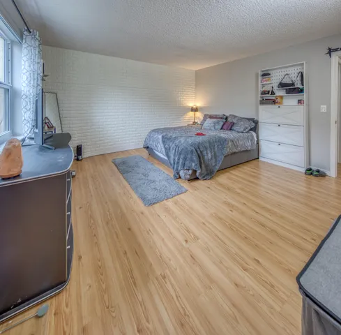 a bedroom with a bed and dresser