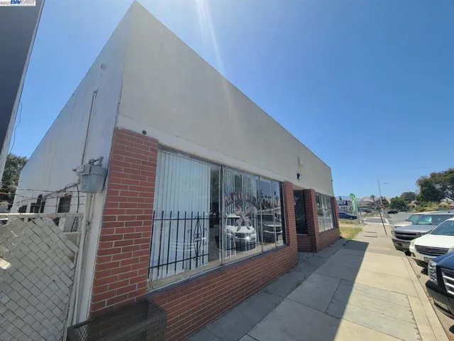 a living room with a black white checkered floor with couches and furniture