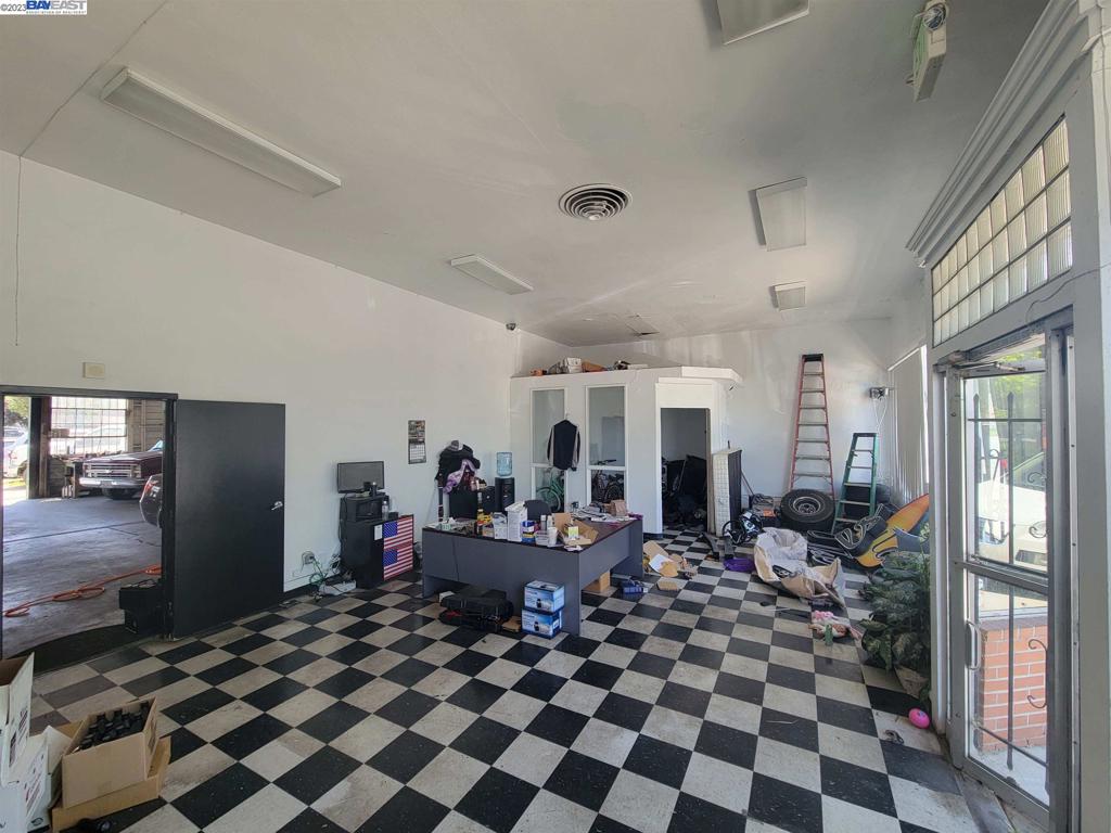 Undisclosed Address Pittsburg, CA 94565 - Photo 3 of 8 a living room with a black white checkered floor with couches and furniture