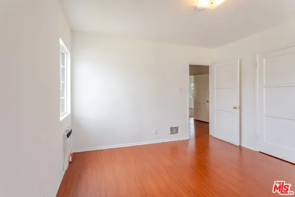 a view of a room with wooden floor