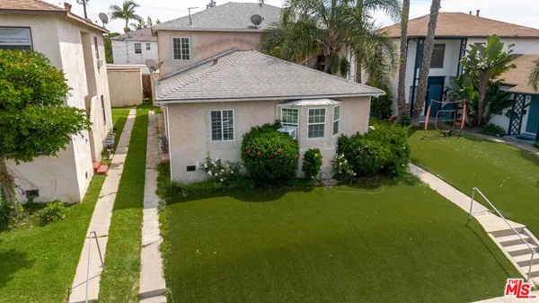 a aerial view of a house with swimming pool next to a yard