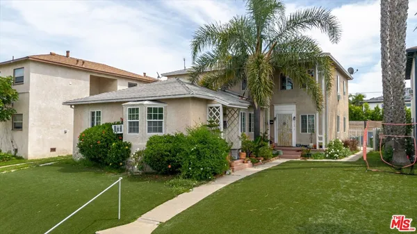 a front view of house with yard and green space