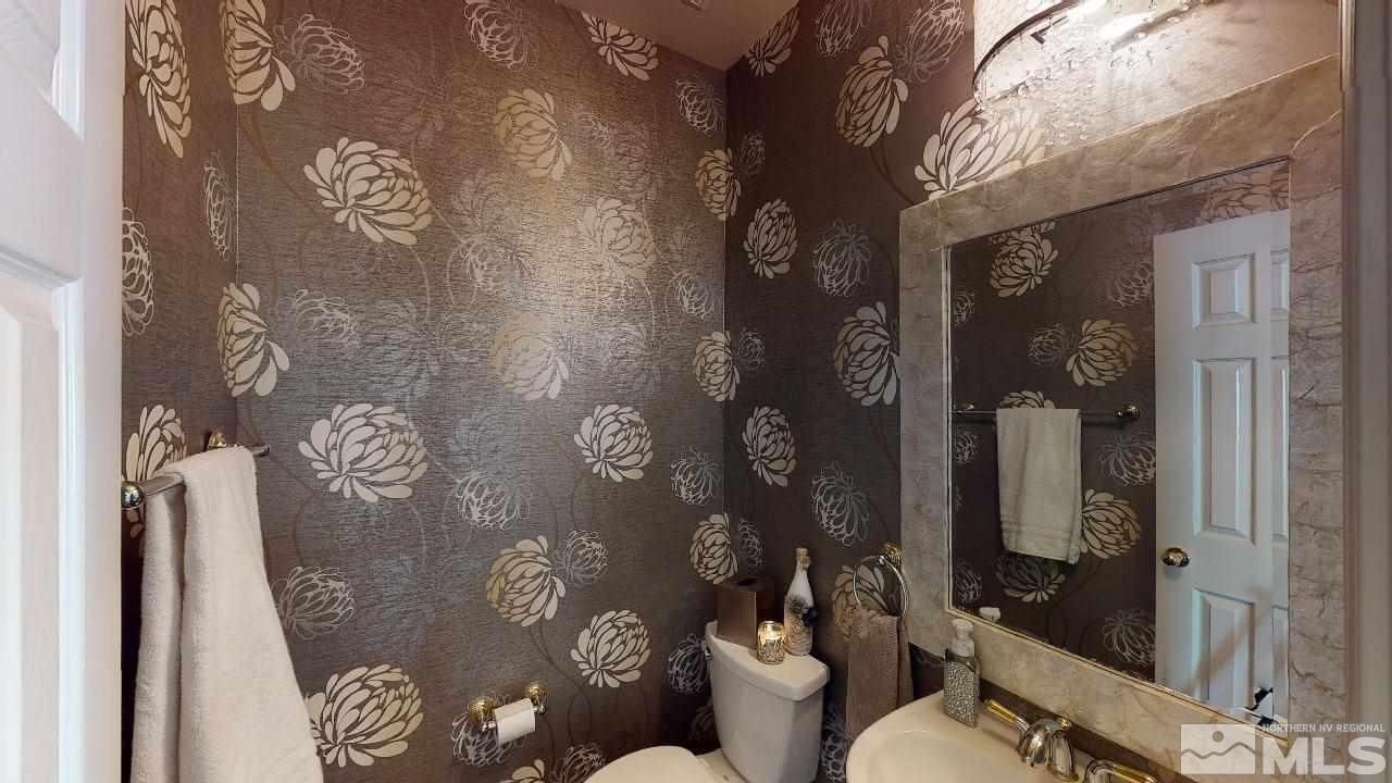 9565 Apache Rose Drive Reno, NV 89521 - Photo 14 of 25 a bathroom with a toilet sink and shower