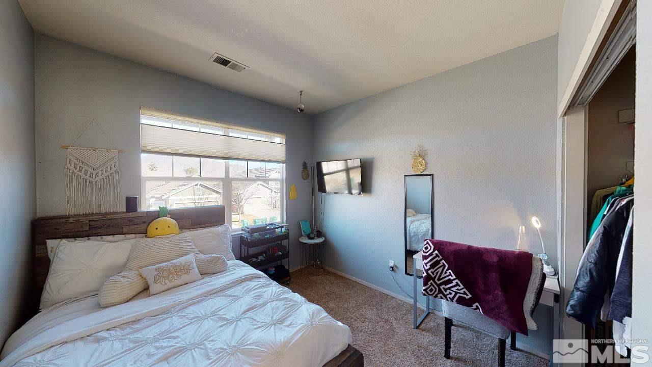 9565 Apache Rose Drive Reno, NV 89521 - Photo 17 of 25 a bedroom with furniture and a window