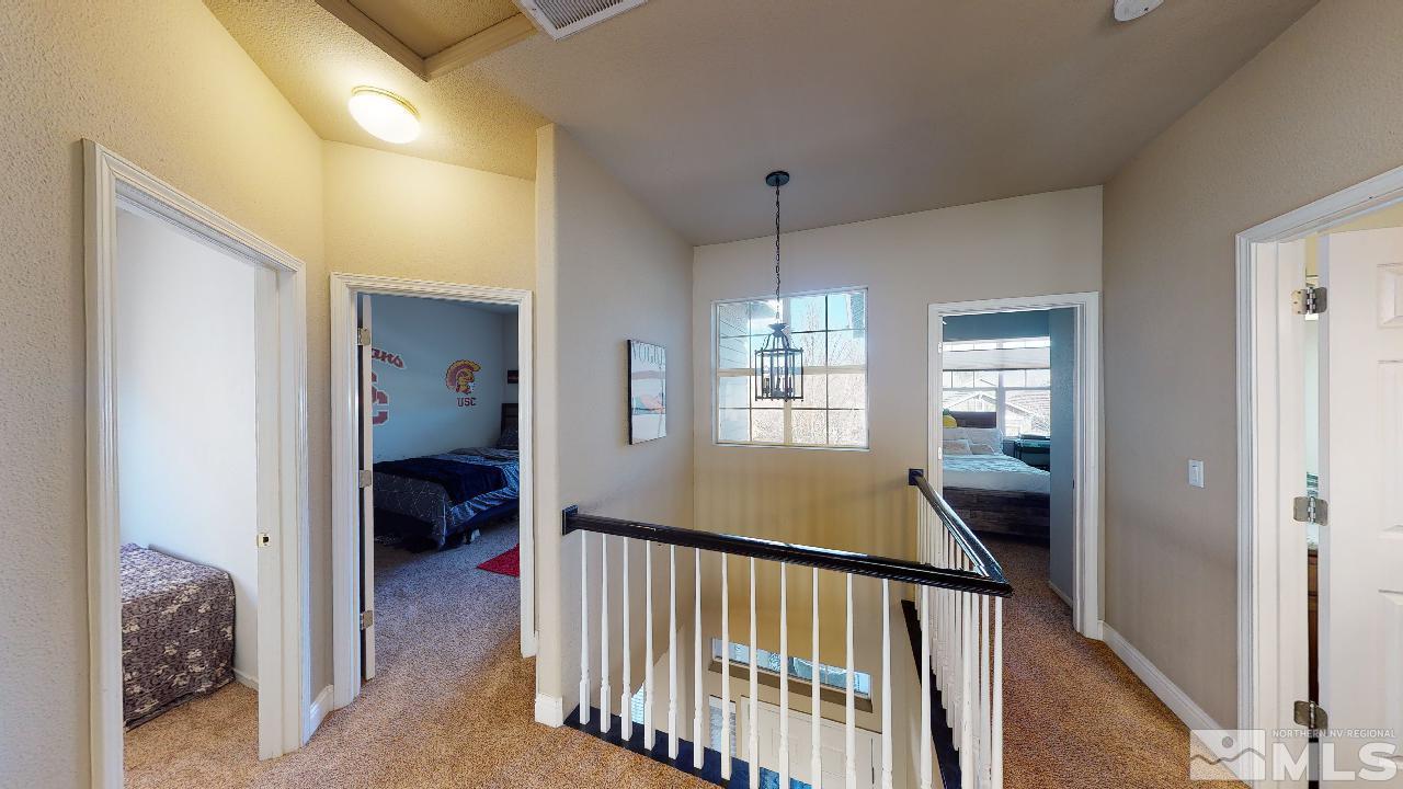 9565 Apache Rose Drive Reno, NV 89521 - Photo 19 of 25 a view of a hallway to a bedroom and a bedroom