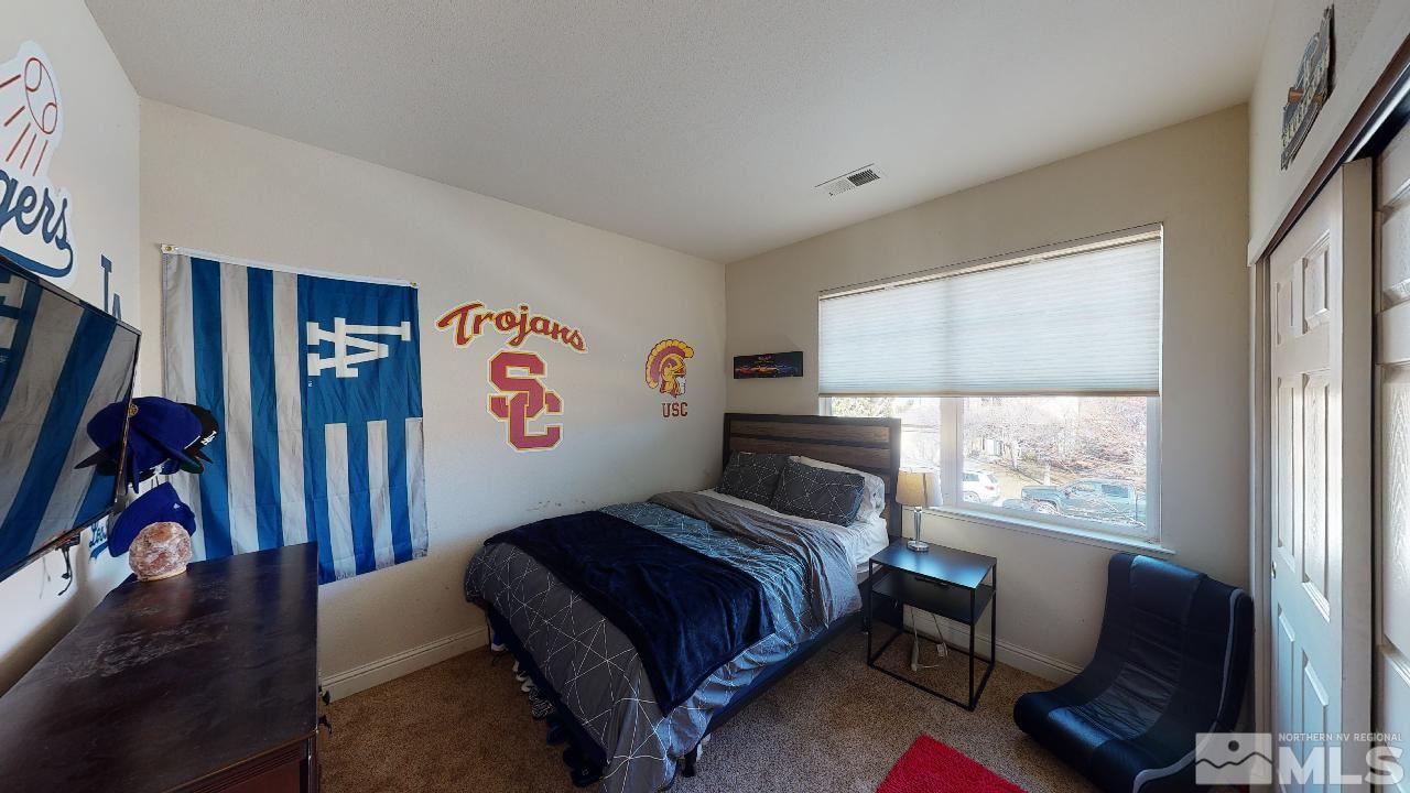 9565 Apache Rose Drive Reno, NV 89521 - Photo 20 of 25 a bedroom with furniture and a window