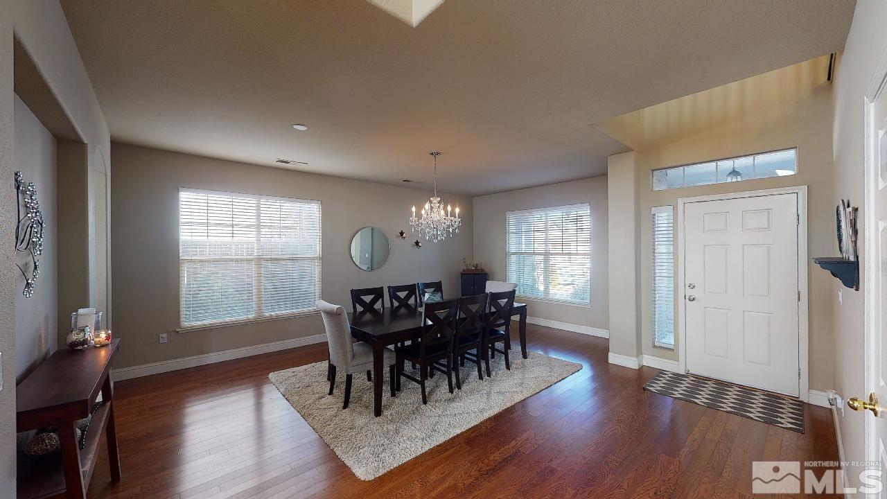 9565 Apache Rose Drive Reno, NV 89521 - Photo 2 of 25 a view of a dining room with furniture window and wooden floor