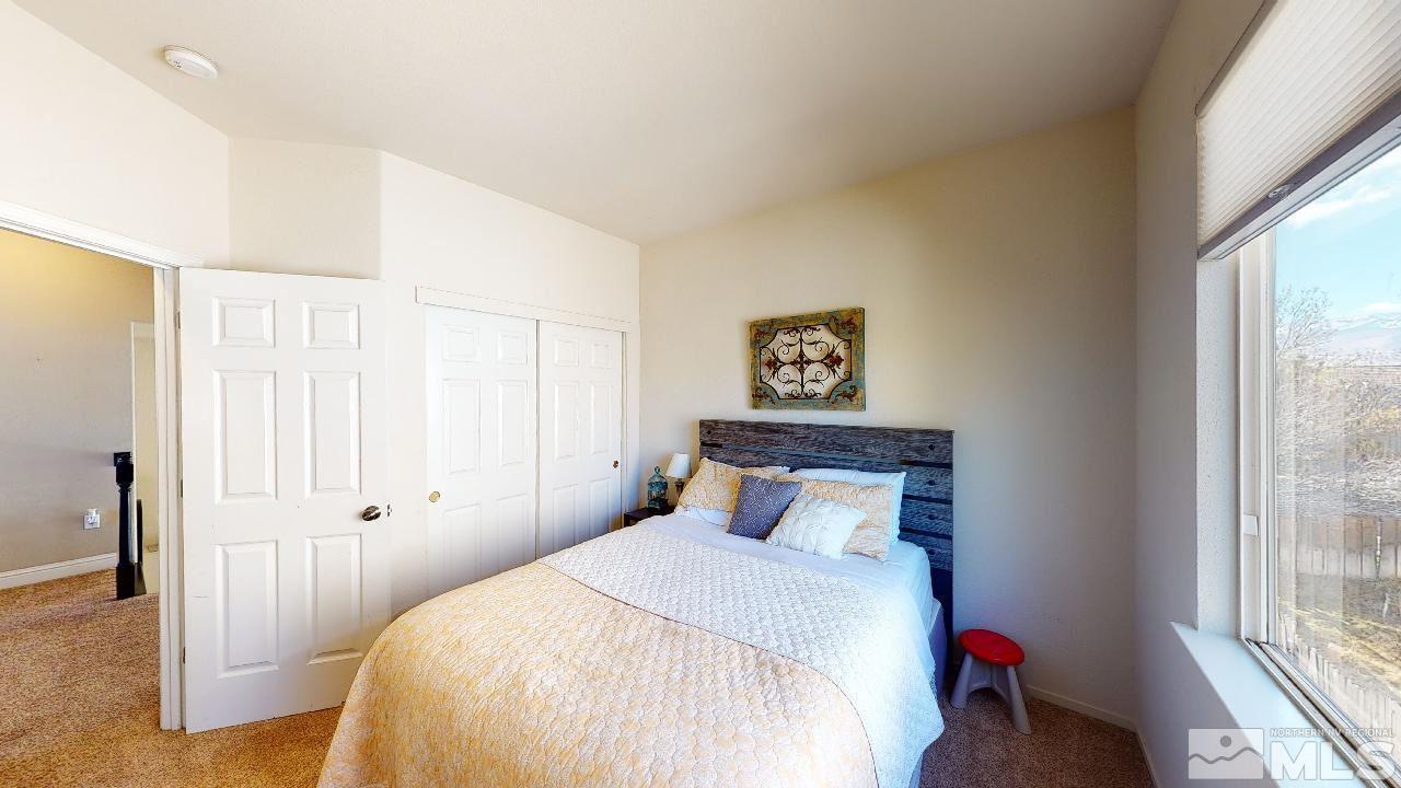 9565 Apache Rose Drive Reno, NV 89521 - Photo 21 of 25 a bedroom with a bed and a window