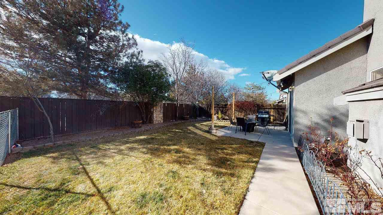 9565 Apache Rose Drive Reno, NV 89521 - Photo 25 of 25 a view of a backyard with table and chairs with wooden fence