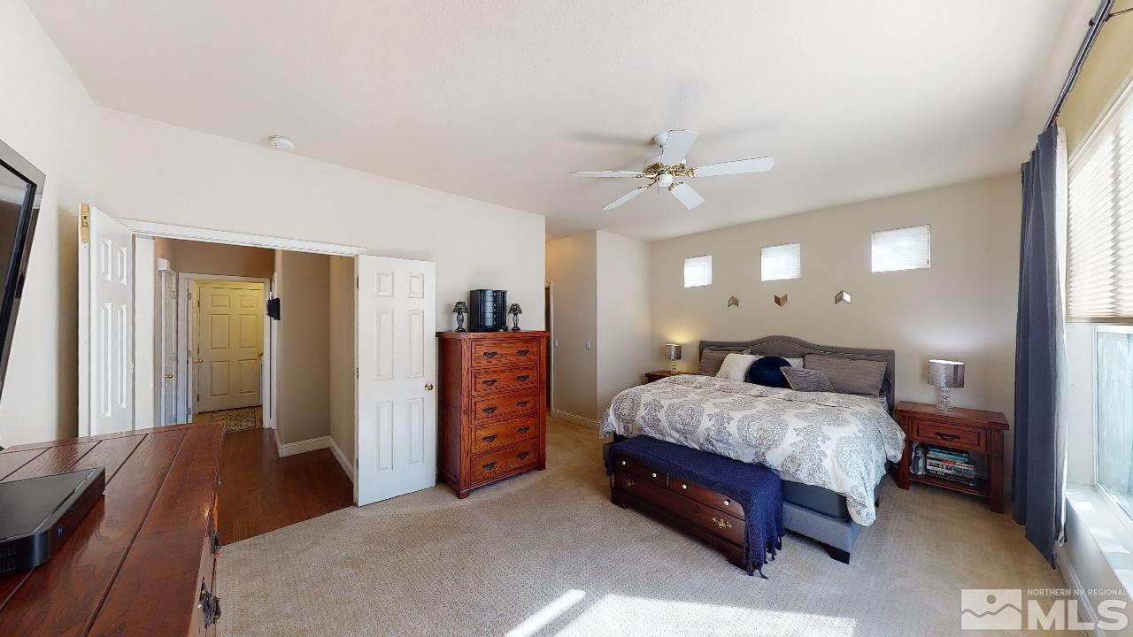 9565 Apache Rose Drive Reno, NV 89521 - Photo 10 of 25 a bedroom with a bed and a chandelier