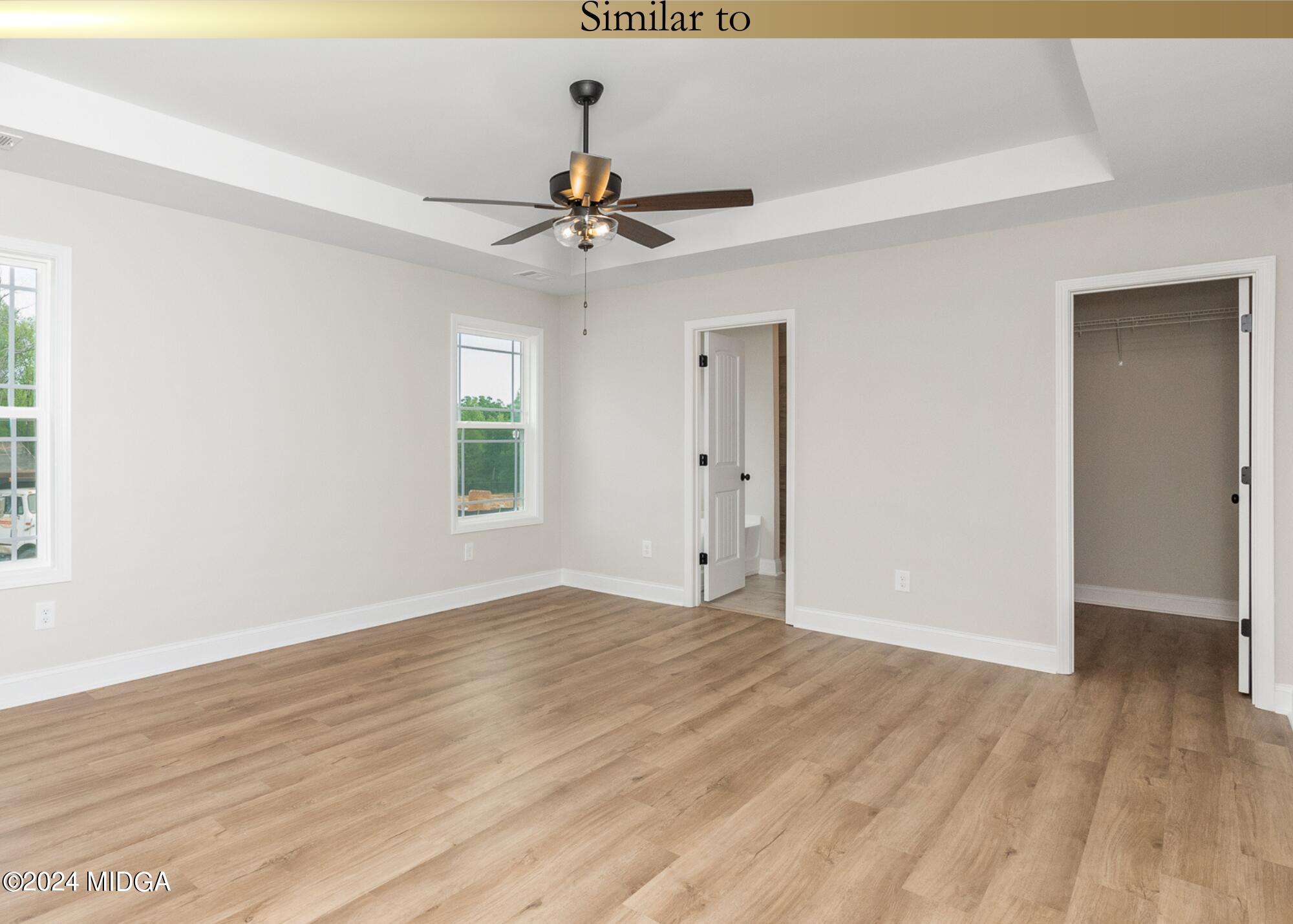 222 Overton Drive Perry, GA 31069 - Photo 12 of 18 a view of an empty room with window and wooden floor