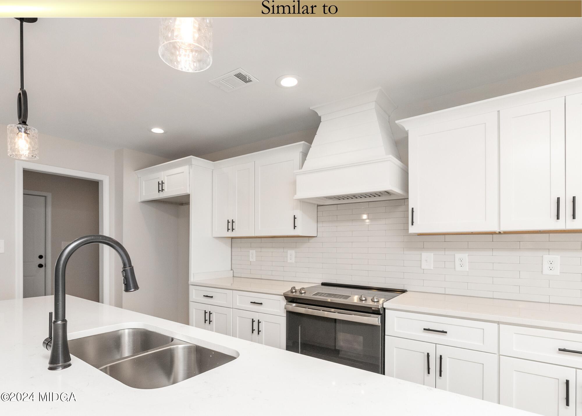 222 Overton Drive Perry, GA 31069 - Photo 7 of 18 a kitchen with granite countertop a sink stainless steel appliances and cabinets