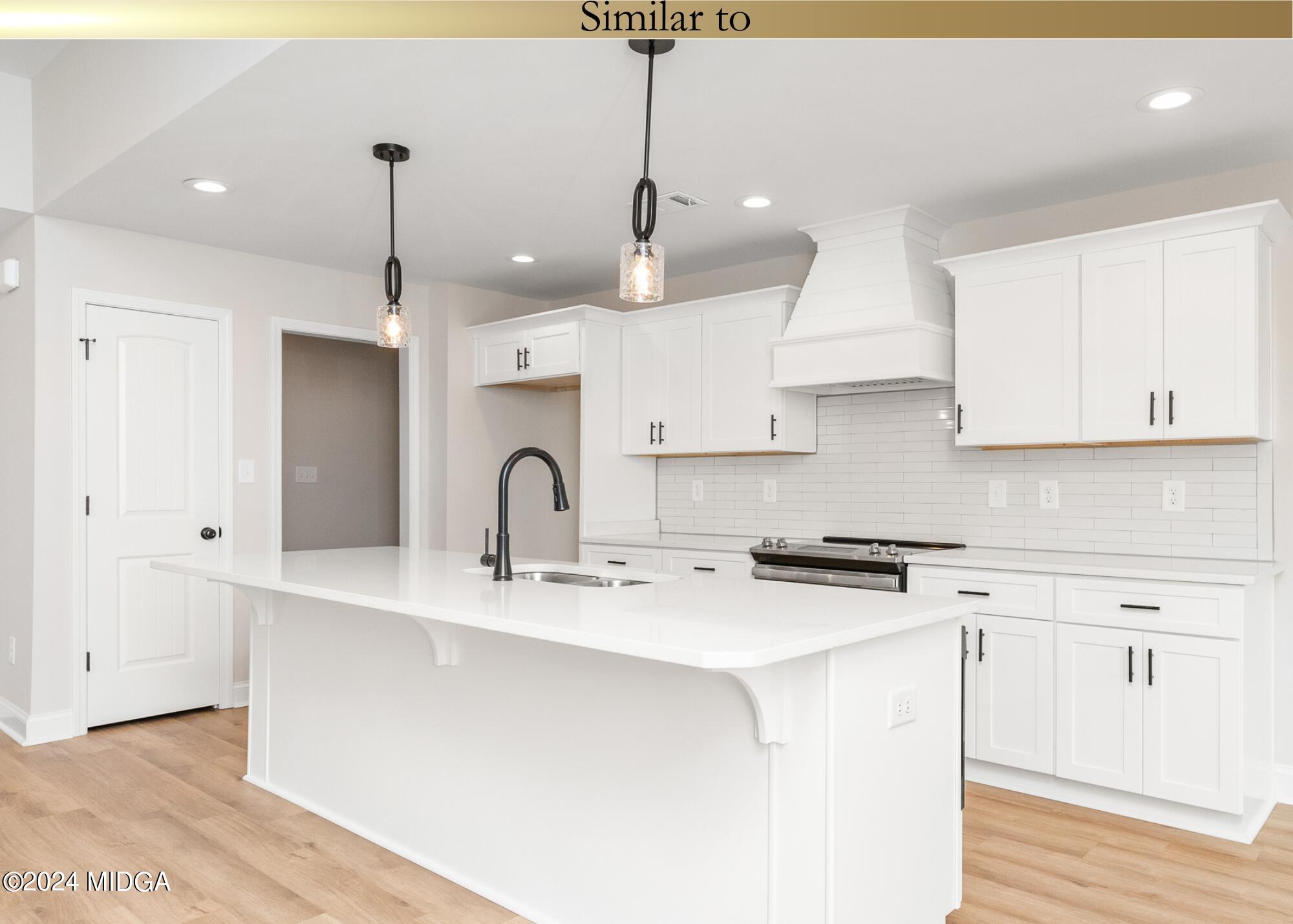 222 Overton Drive Perry, GA 31069 - Photo 8 of 18 a kitchen with stainless steel appliances granite countertop a sink a stove a refrigerator and white cabinets